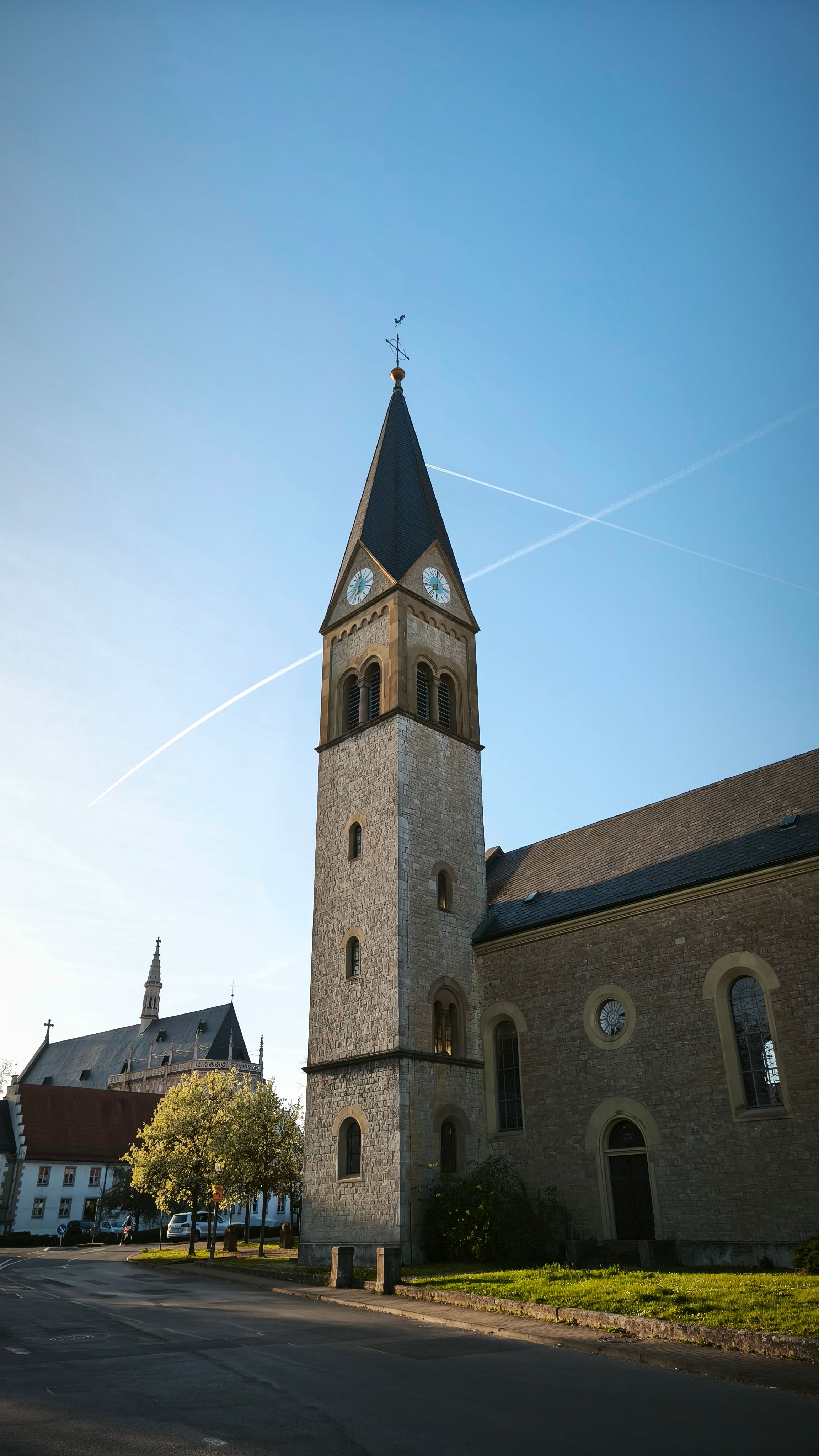 Gratis Affascinante chiesa in pietra con un alto campanile sotto un limpido cielo azzurro in Germania. Foto a disposizione