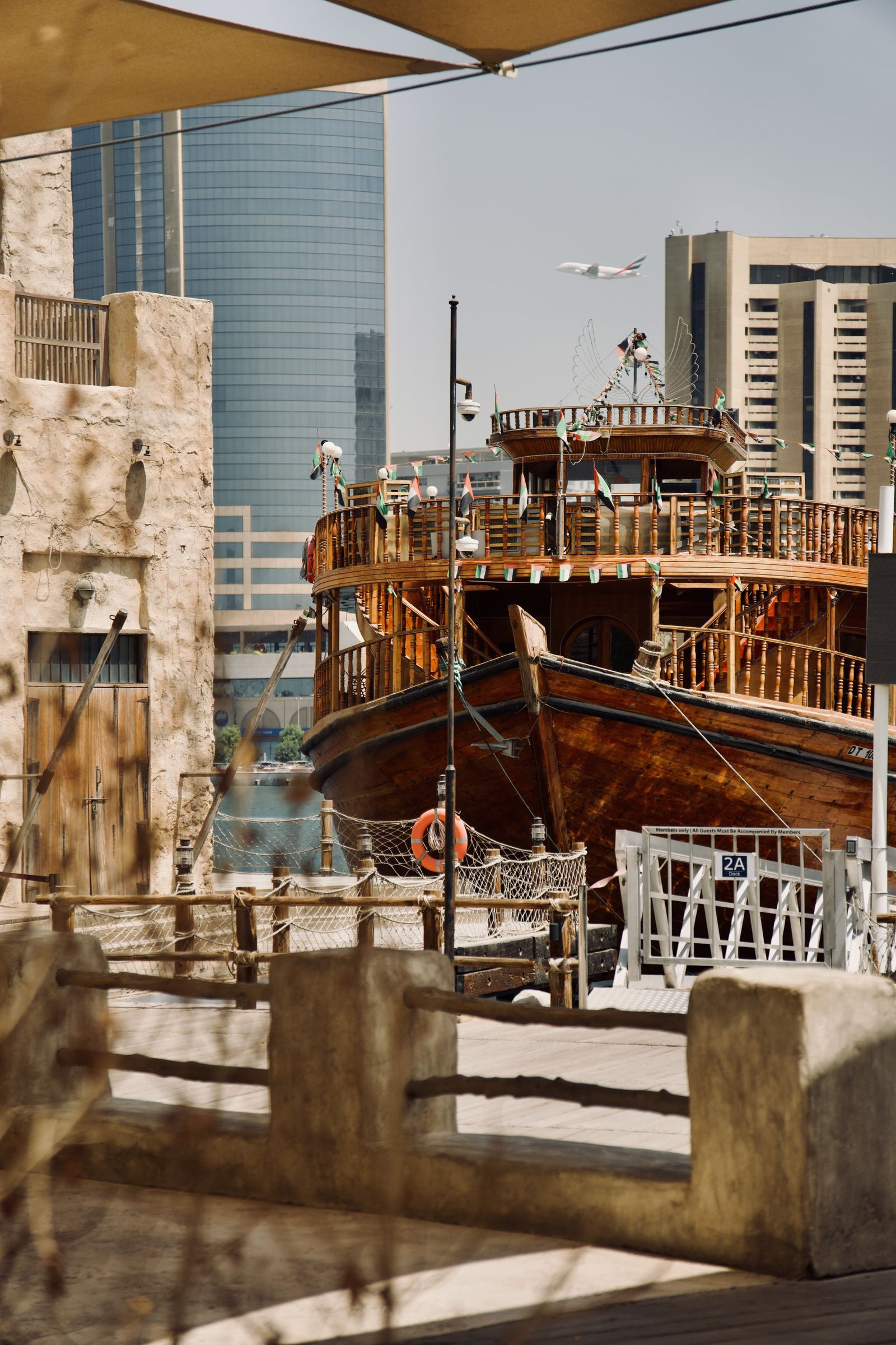 Traditional dhow in Dubai Marina with skyscrapers behind