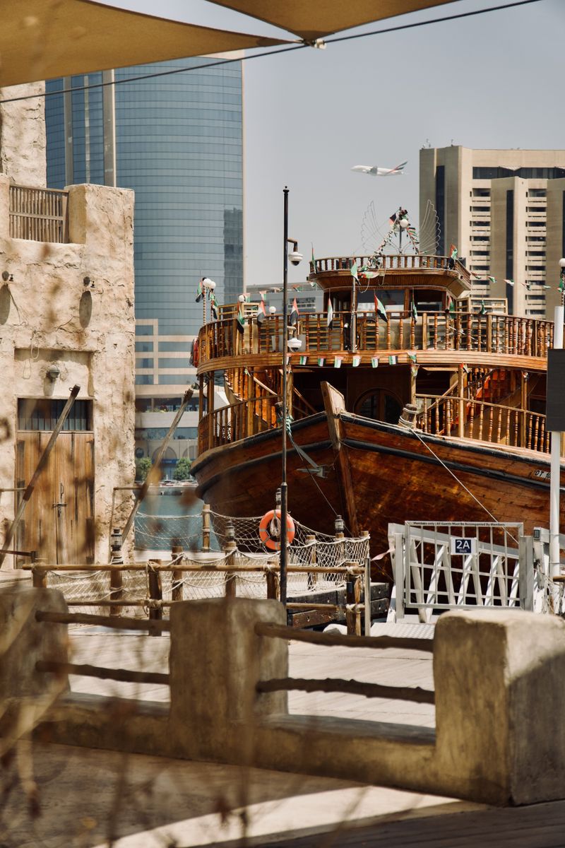 Traditional dhow in Dubai Marina with skyscrapers behind