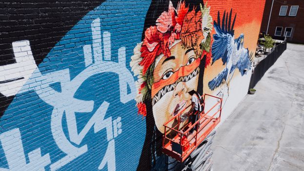 Colorful mural depicting cultural themes on a wall in Chattanooga, Tennessee.