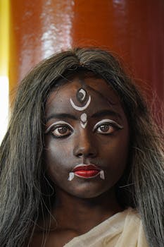 Close-up portrait of woman with intricate traditional makeup and face paint