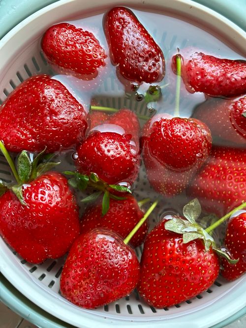 Free Vibrant fresh red strawberries soaking in a colander with water, ideal for healthy eating concepts. Stock Photo