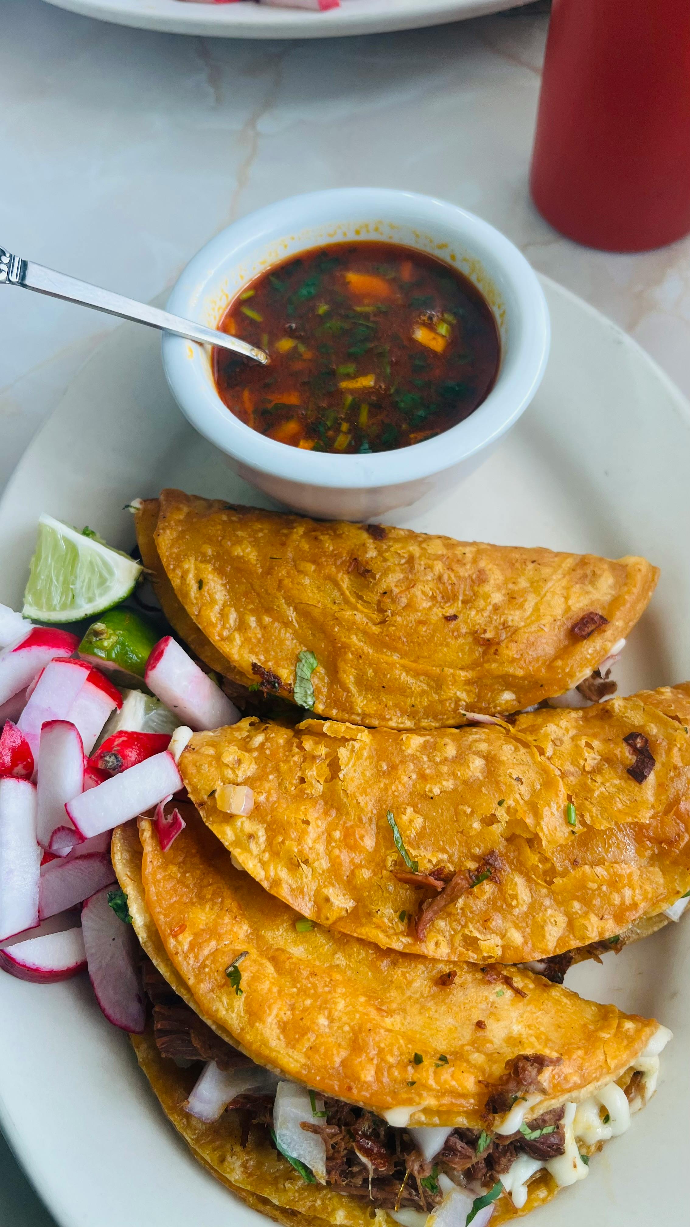 Birria Mixed Tray - Best of both worlds! 9 birria baos, 9 birria tacos, 6 cups consommé, one cup limes, and one cup vegg