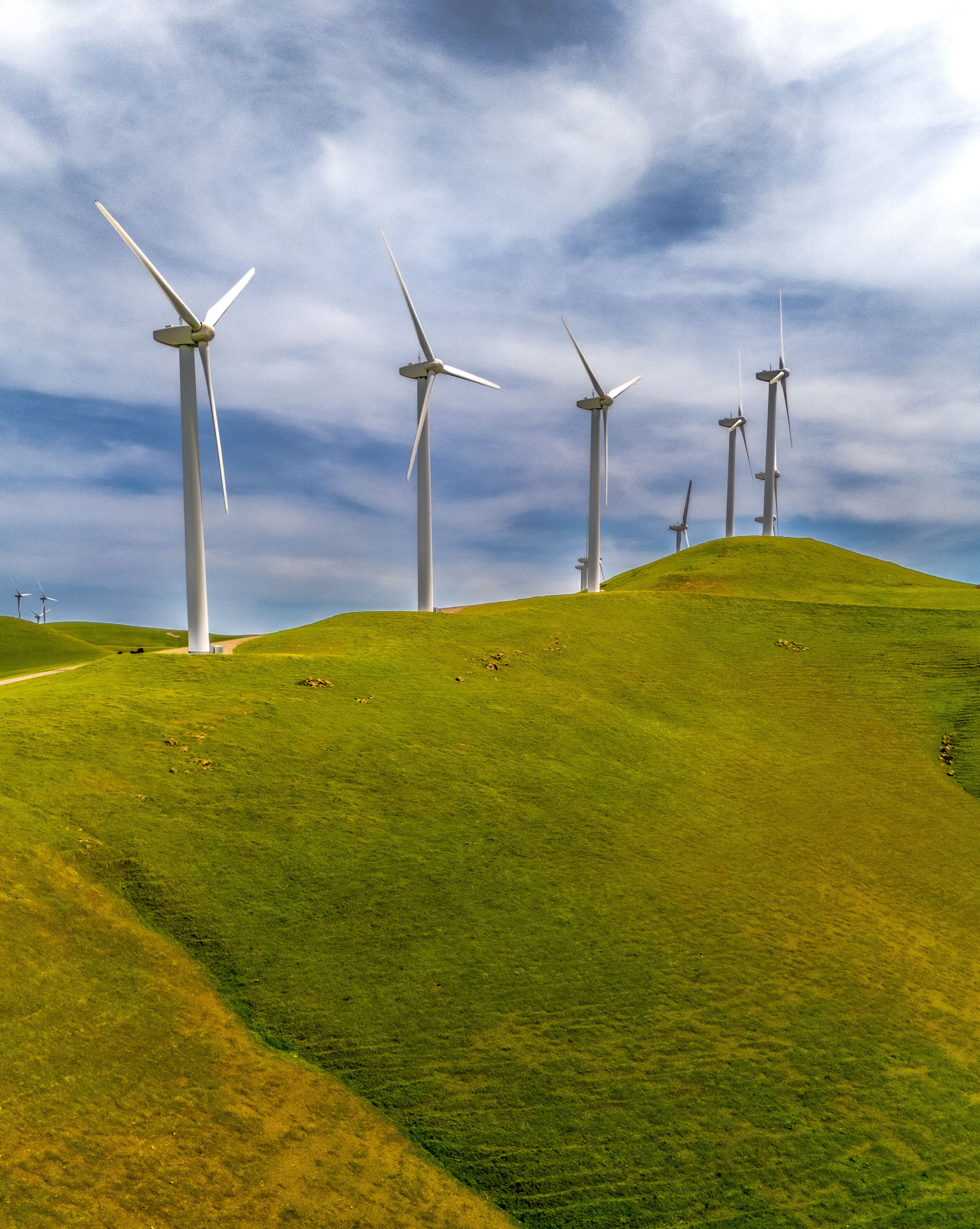 Aerial View of Wind Turbines on Green Hills · Free Stock Photo