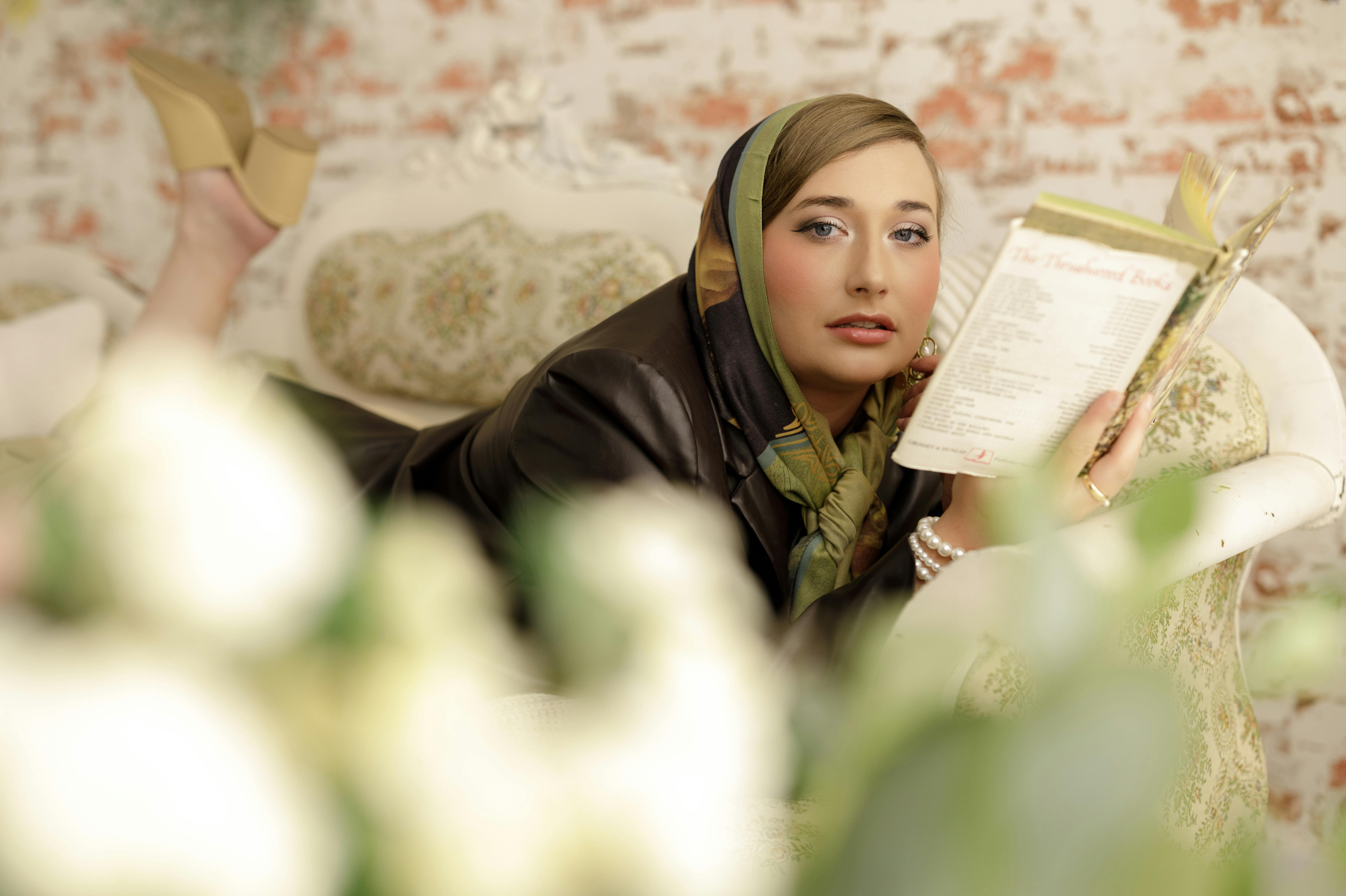 Stylish woman reading a menu in a vintage-themed room, evoking a classic mood.