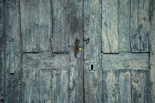 Free A vintage turquoise wooden door with rustic textures and an antique lock, showcasing colonial architectural style. Stock Photo