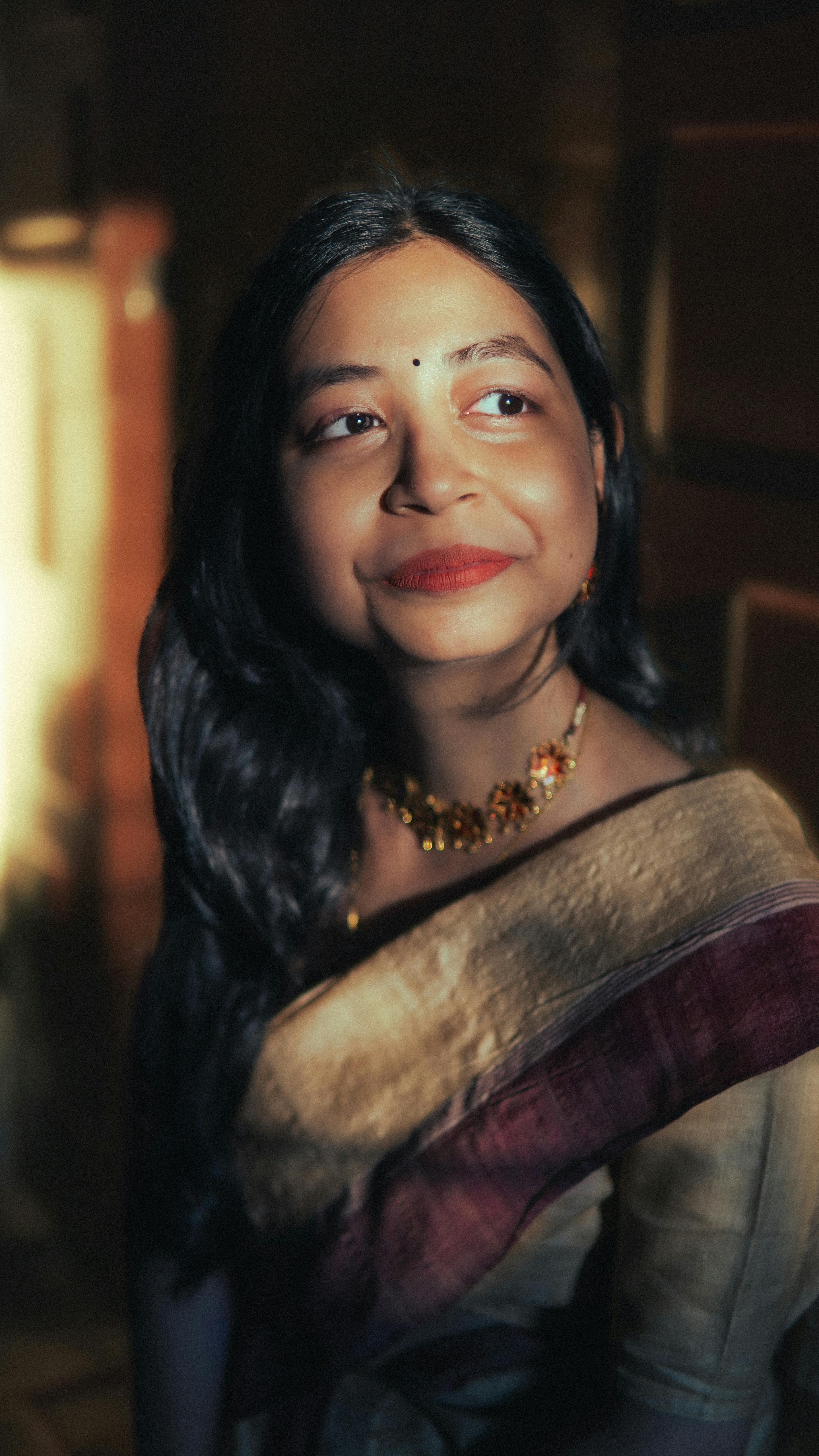 Portrait of a woman in traditional Indian attire during golden hour, showcasing grace and culture.
