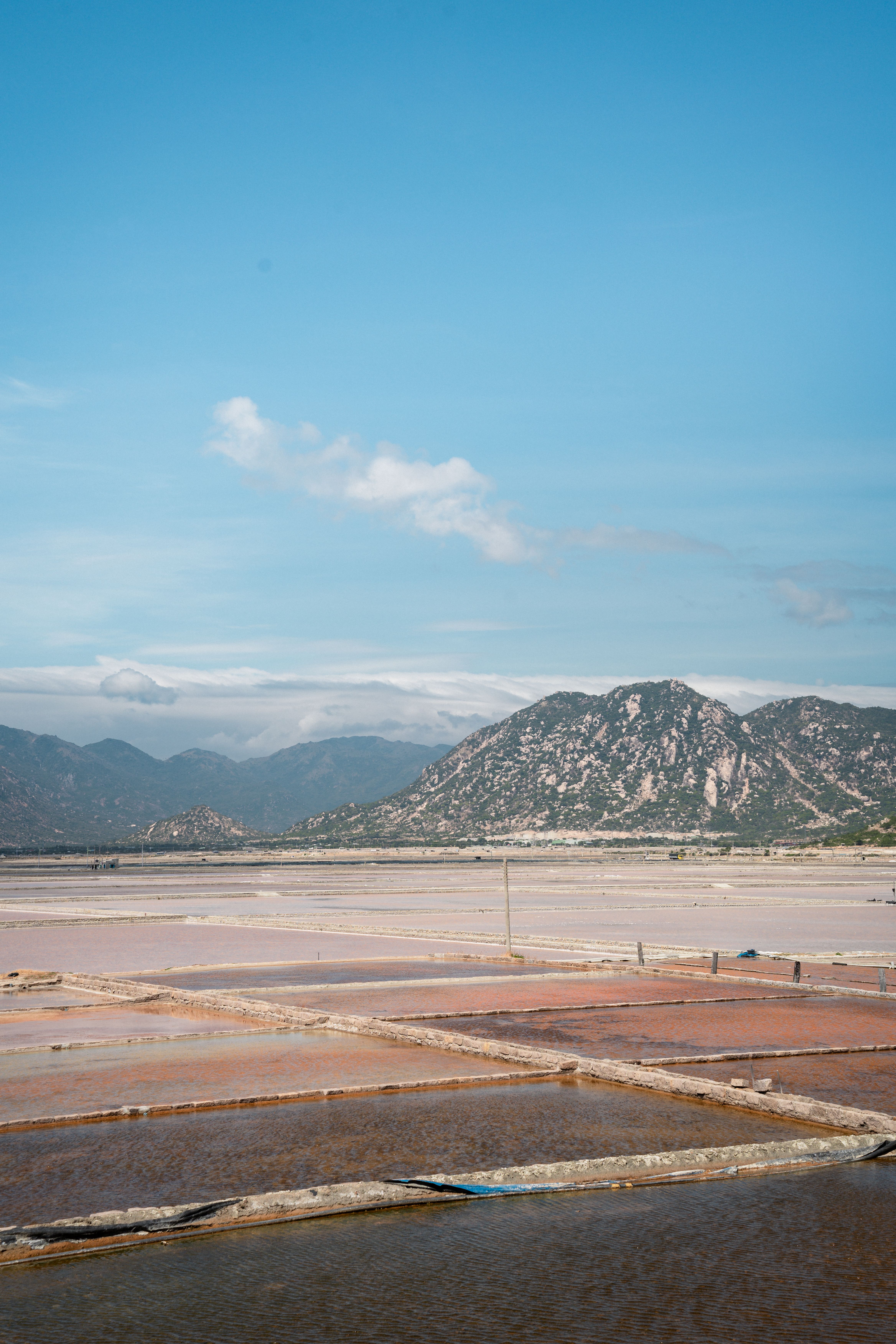 Scenic Salt Fields Under a Clear Blue Sky · Free Stock Photo