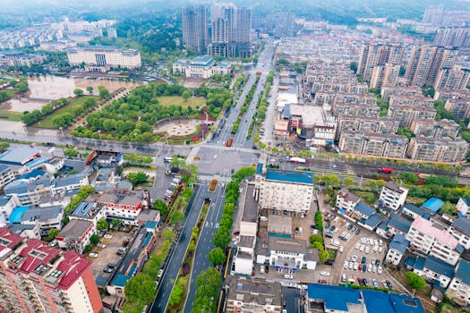 Vibrant aerial view of urban landscape with greenery and modern architecture in China.
