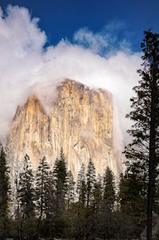 Stunning view of El Capitan shrouded by clouds in Yosemite National Park, a natural wonder of California.