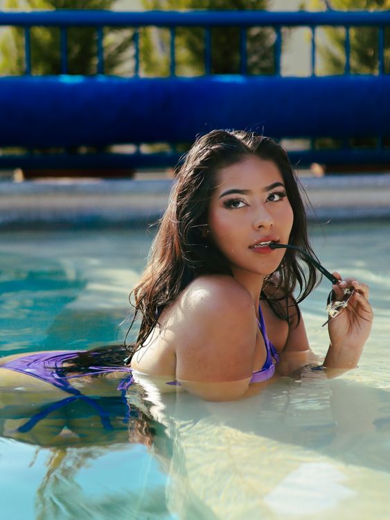Young Woman Relaxing in a Sunny Pool · Free Stock Photo