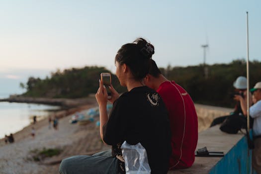 A tranquil scene of people enjoying a sunset at Bình Thuận beach, Vietnam.