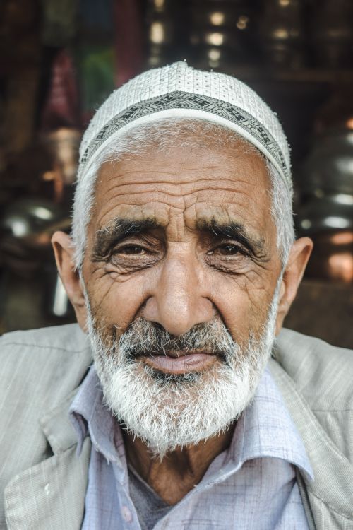 Free A striking portrait of an elderly man in traditional attire showcasing rich cultural heritage in Srinagar. Stock Photo