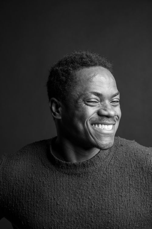 Free A black and white portrait of a smiling adult conveying joy and positivity. Stock Photo