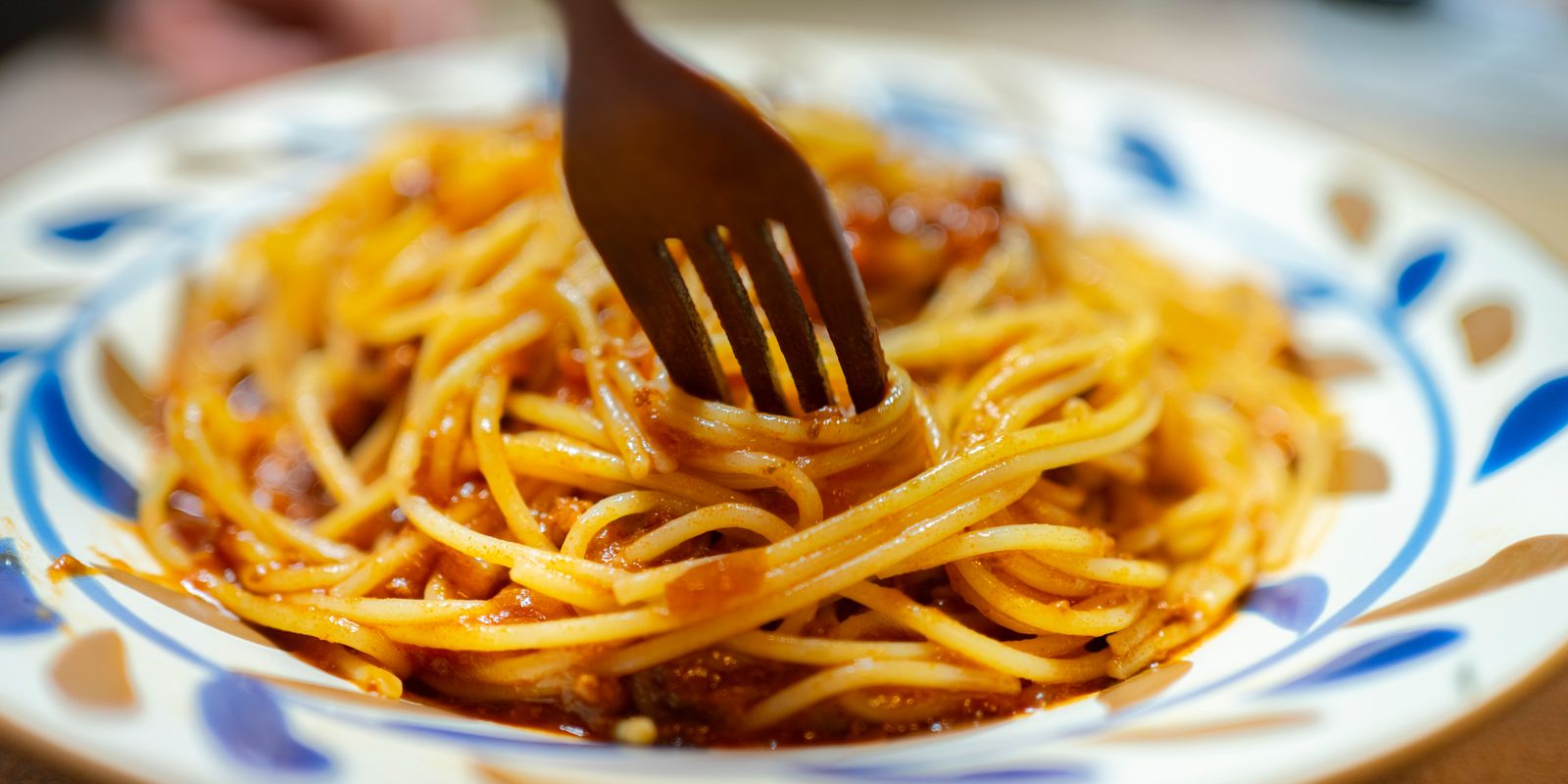 A plate of spaghetti with rich tomato sauce ready to eat