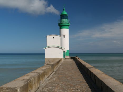 Serene view of a lighthouse on the Normandy coast, perfect for peaceful getaway imagery.