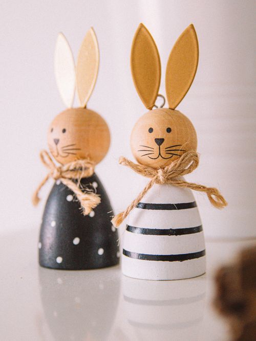Free Charming decorative wooden rabbits with golden ears and twine bows, perfect for festive decor. Stock Photo