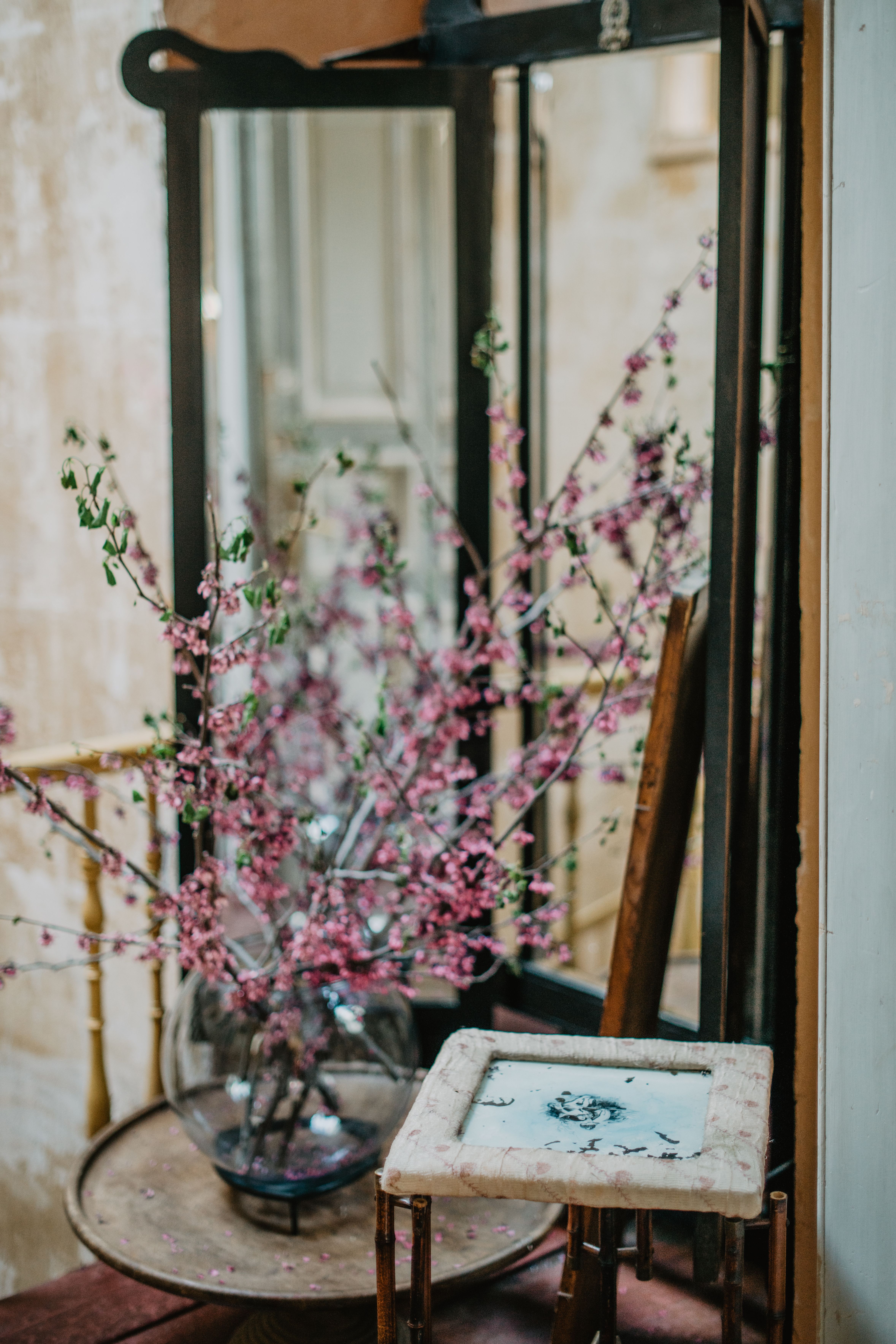Vintage wooden folding mirror beside a rustic wooden table