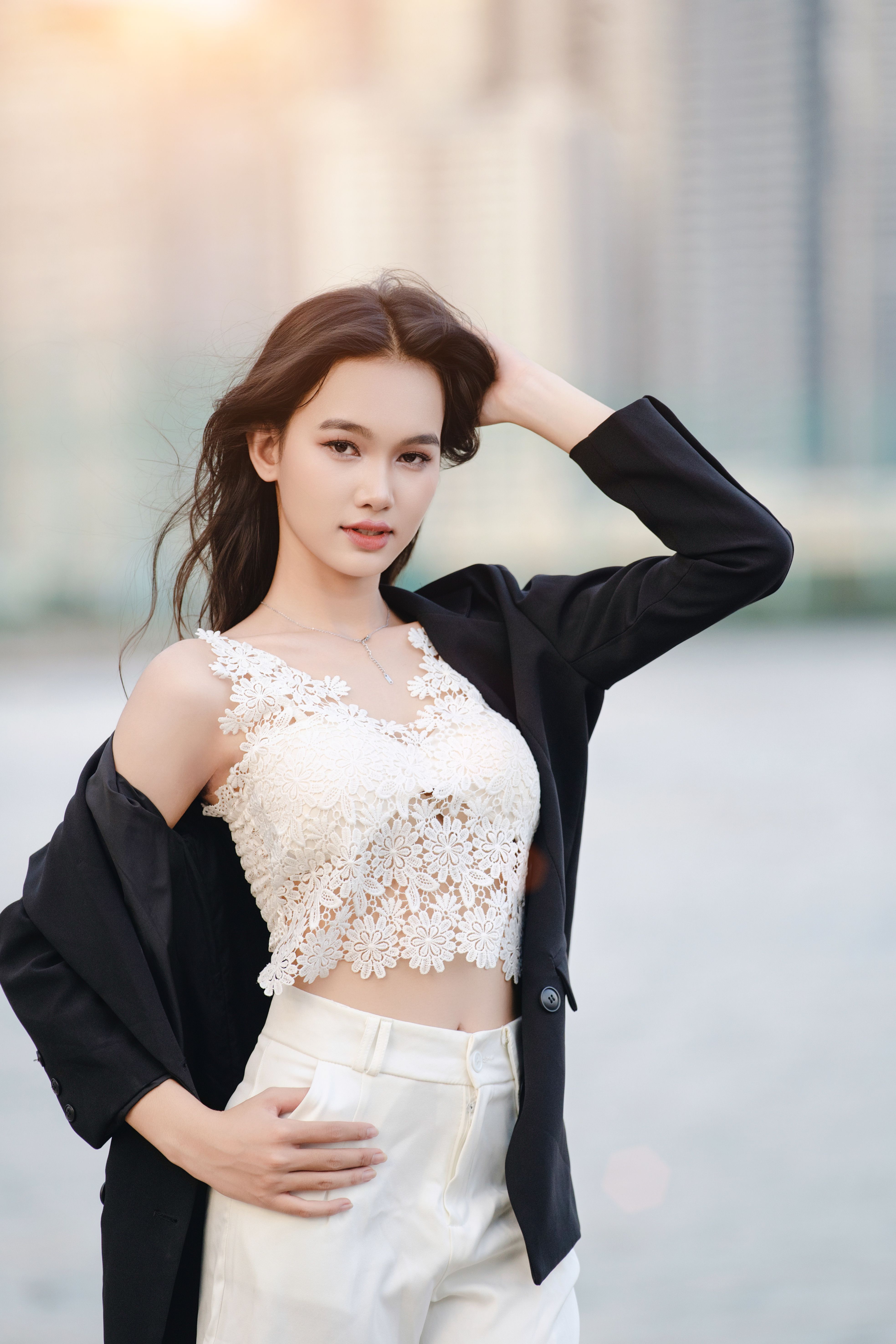 Stylish Woman in Urban Setting at Sunset · Free Stock Photo
