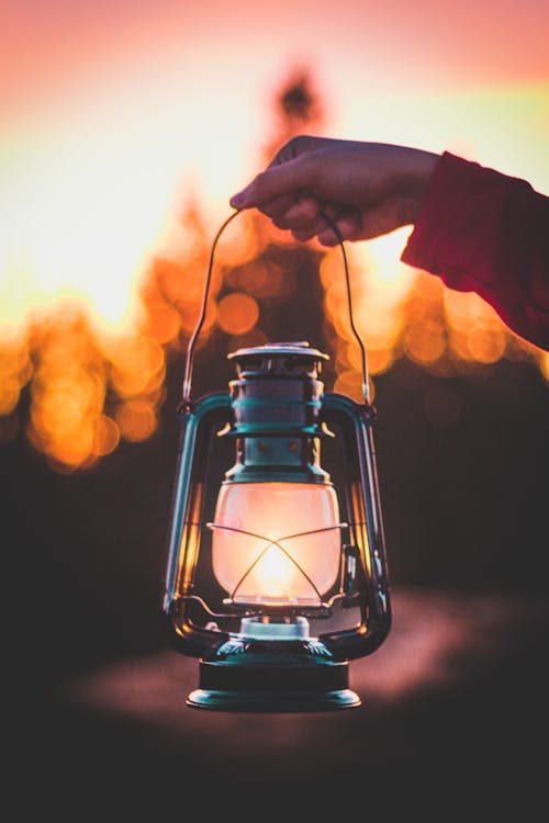 Photo Of Person Holding Lamp