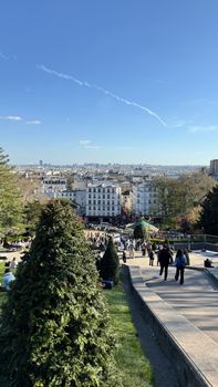 Scenic view of Paris from Montmartre on a sunny day with clear skies and people exploring.