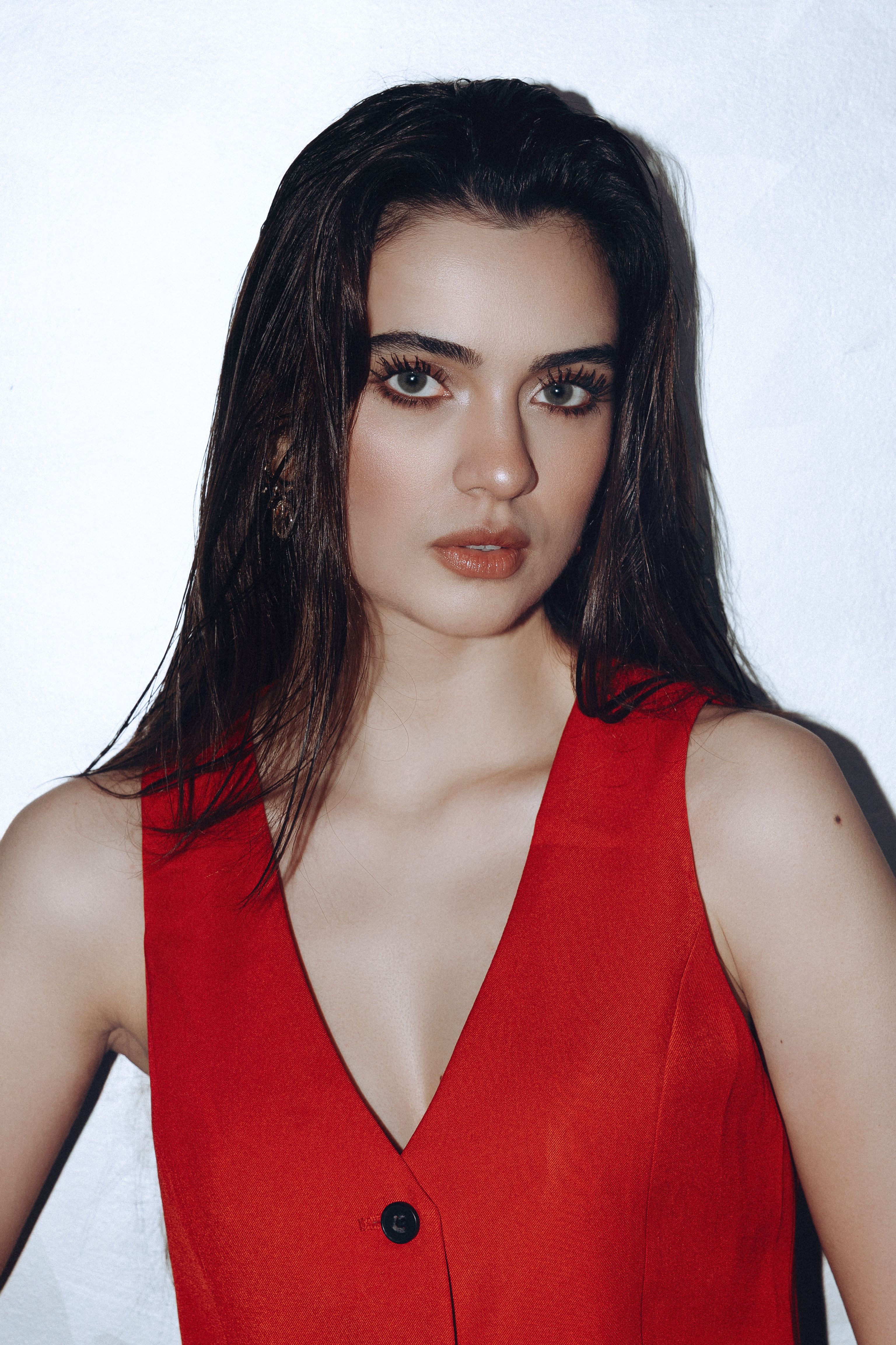 Portrait of a woman in a red dress with a white background, İstanbul, Türkiye.