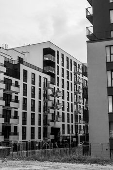 Black and white photo of sleek, modern apartment buildings with balconies.
