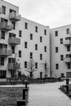 Black and white photo of modern urban apartment buildings with balconies.