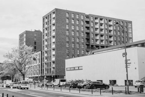 Free Black and white urban view showcasing modern apartment buildings and city life. Stock Photo