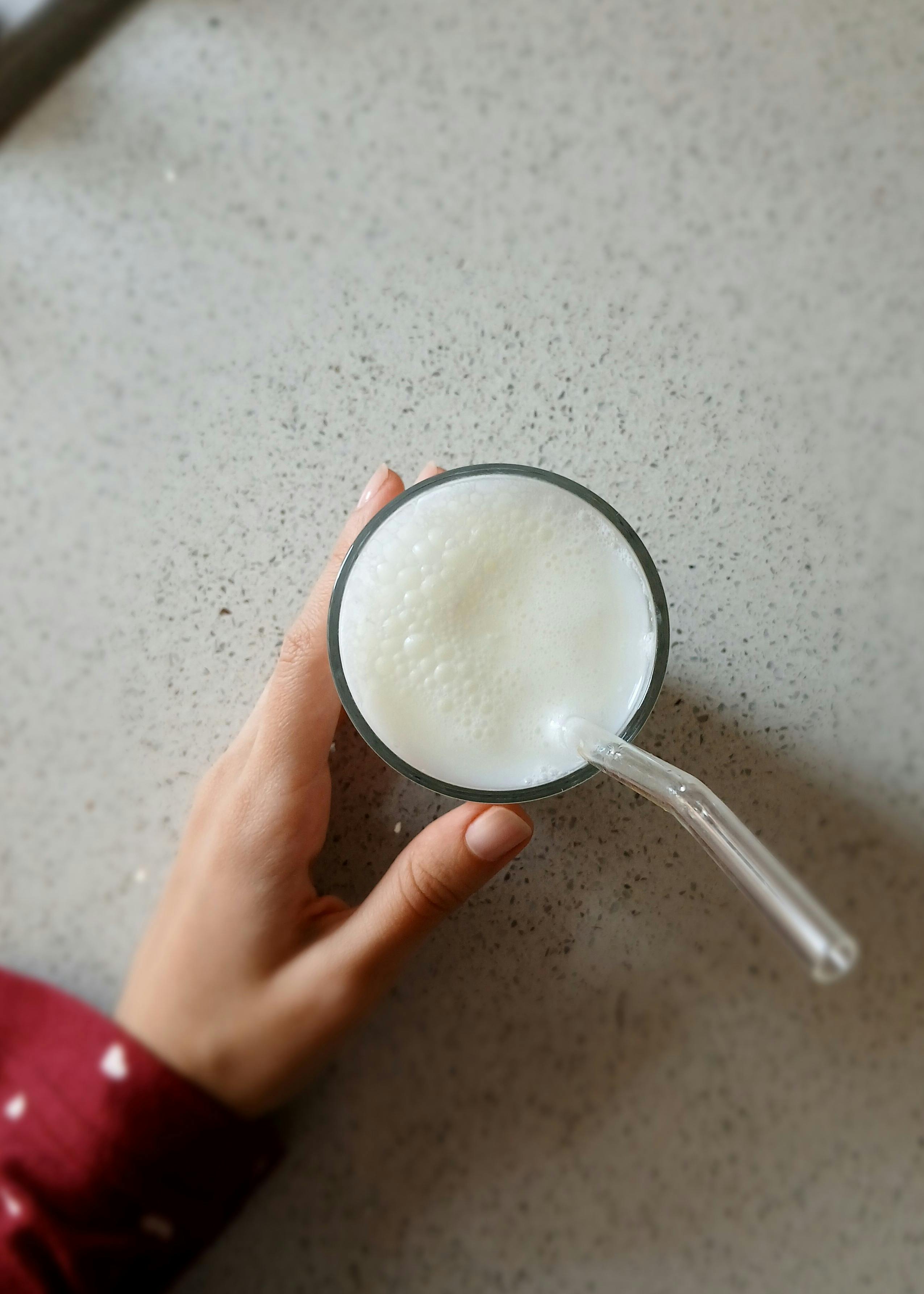 Woman blending green smoothie in a kitchen