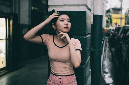 Free Stylish young woman posing in an urban setting, showcasing modern street fashion. Stock Photo