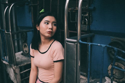 Women's Pink Scoop-neck Cap-sleeved Shirt Sitting On The Rear End Of A Jeep