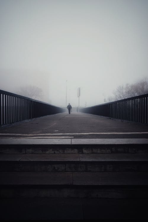 Person Walking on Footbridge