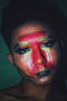 Vibrant portrait showcasing a man's face with colorful artistic makeup.