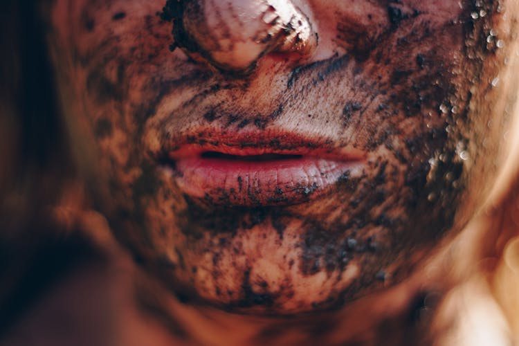 Person's Face Covered With Mud