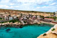 Picturesque view of Popeye Village with azure waters and unique architecture, Malta.