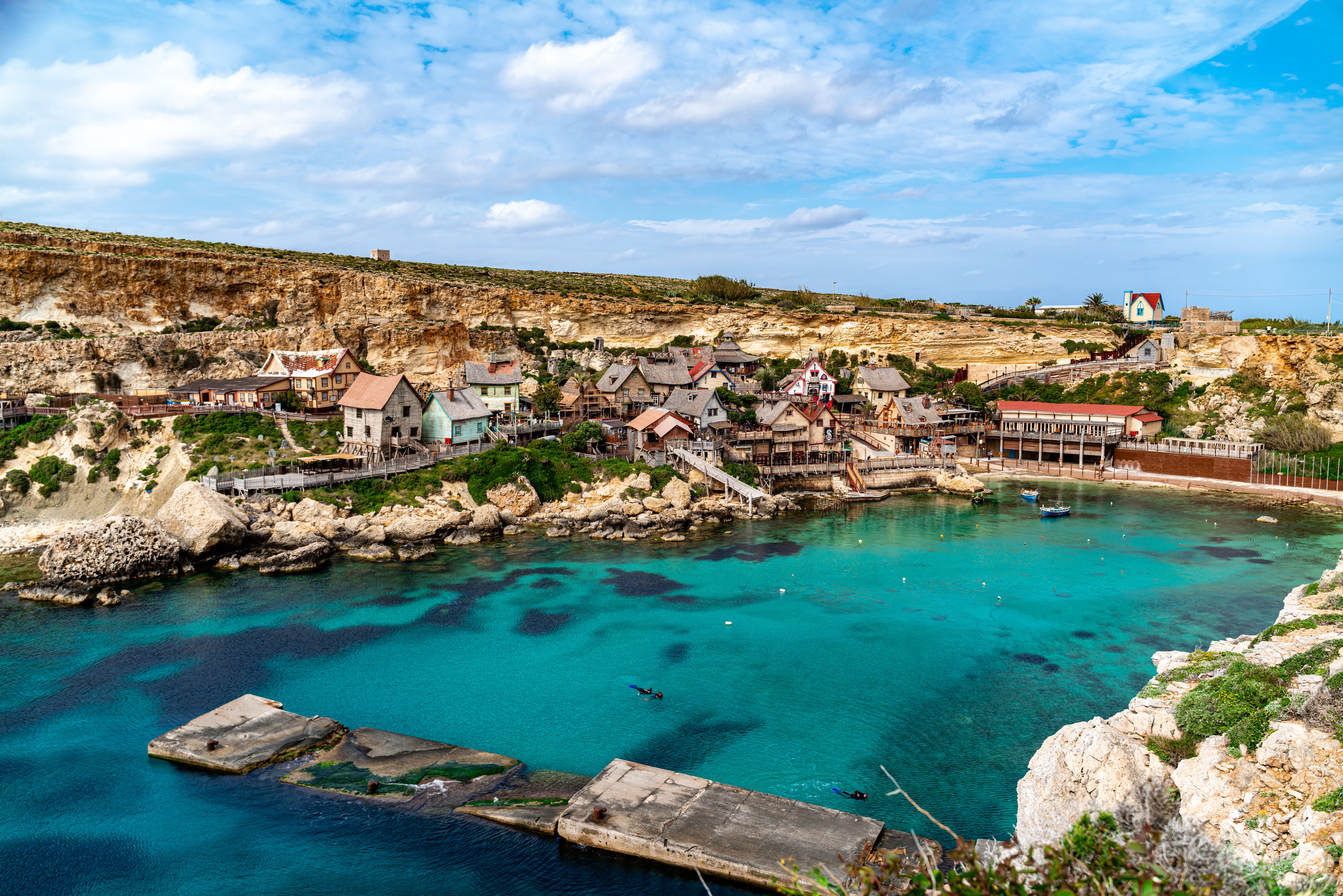 View of the Maltese coastline with medieval fortifications, reminiscent of King
