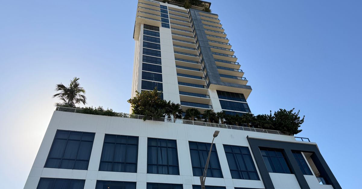 Tall modern high-rise building with clear sky background, architectural design.
