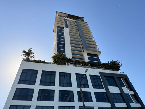 Tall modern high-rise building with clear sky background, architectural design.