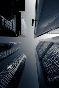 Dramatic low-angle shot of tall skyscrapers in Frankfurt, highlighting modern urban architecture.