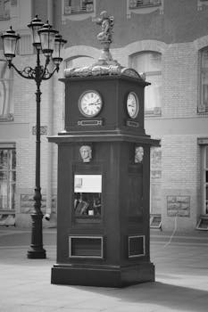 Black and white photo of a vintage clock tower in Saint Petersburg, Russia, showcasing classic architecture.