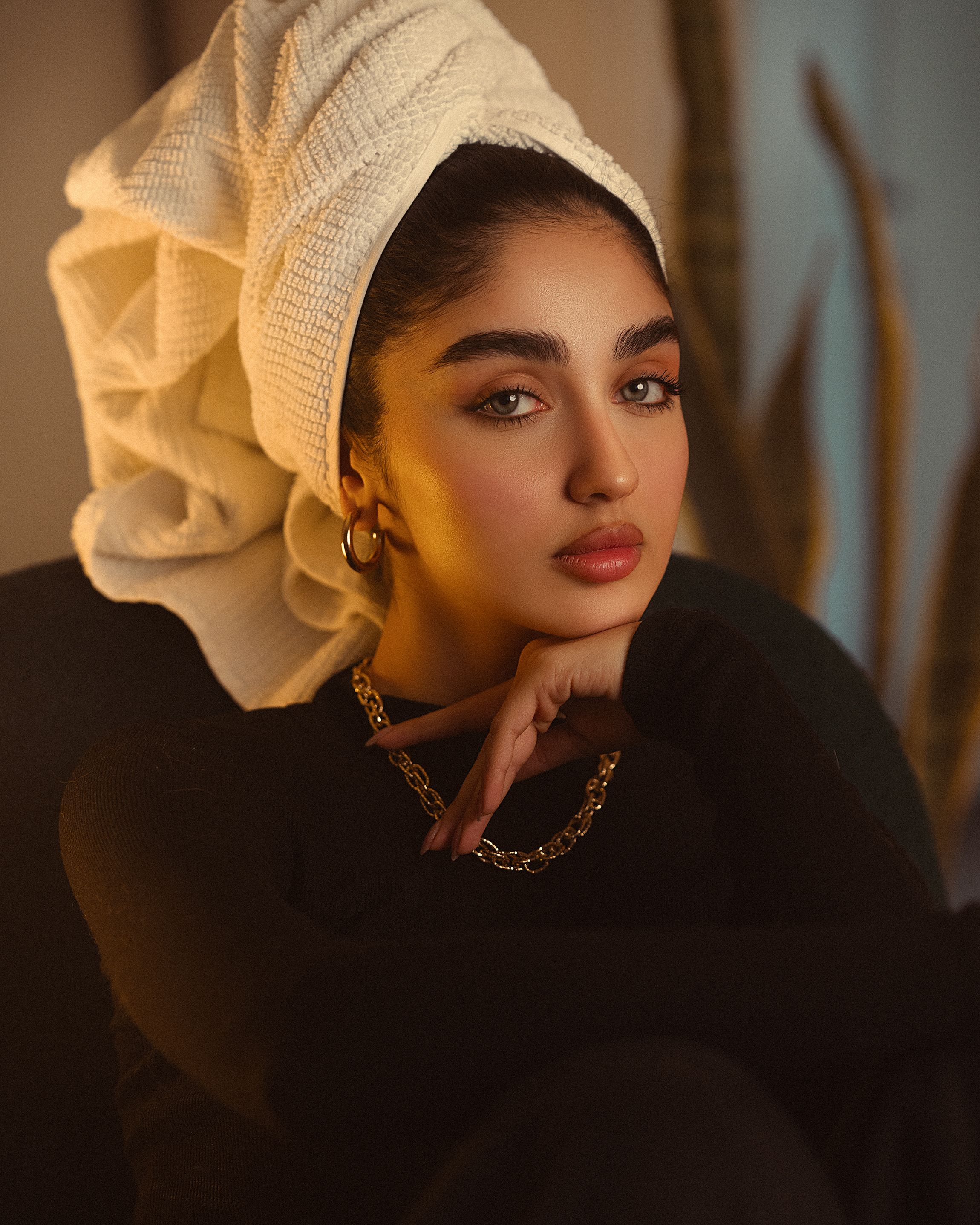 Stylish portrait featuring a woman with a towel turban, showcasing modern fashion elegance.