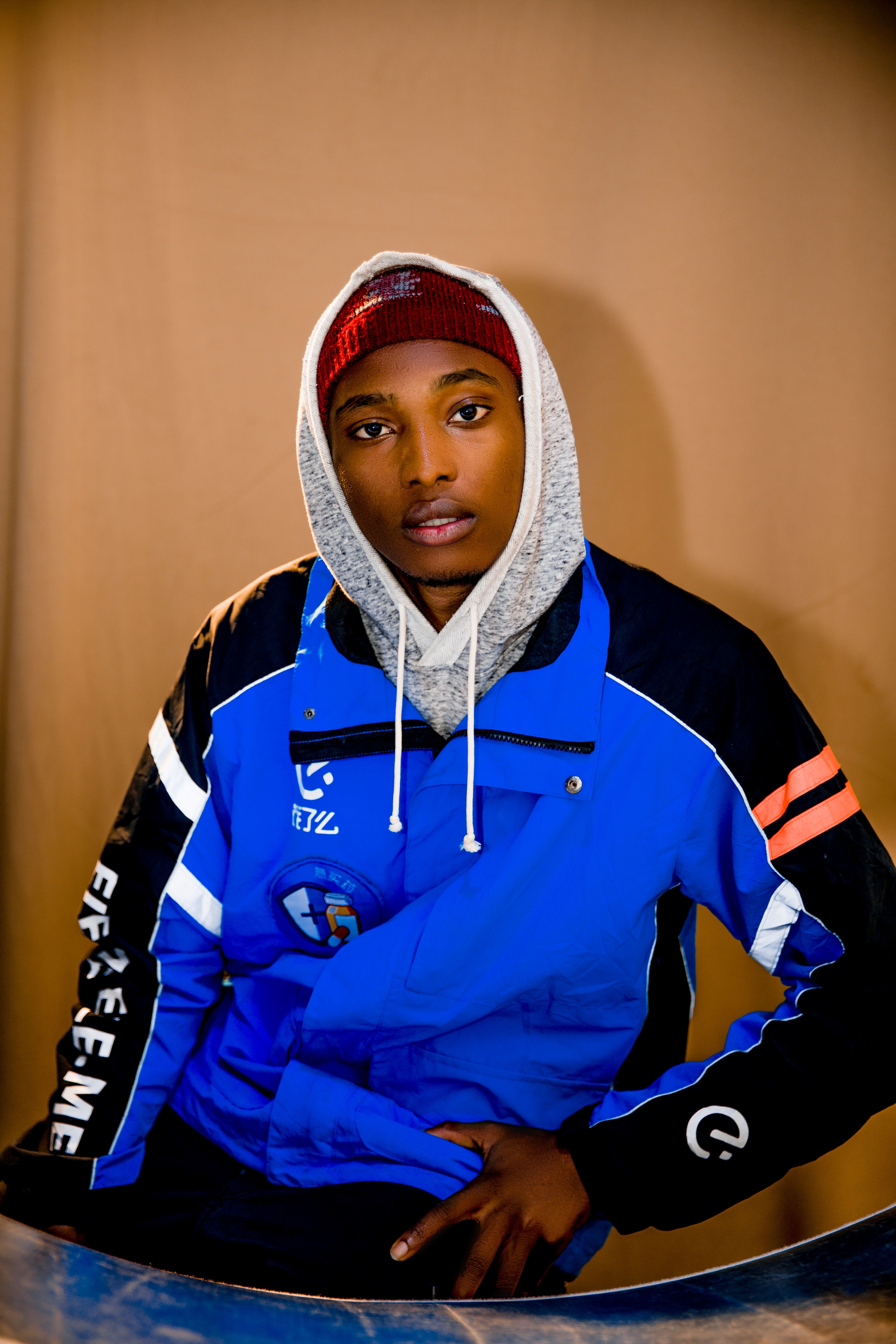 Portrait of a young man in a stylish blue jacket indoors.