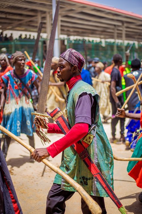 Free Vibrant cultural fest features warriors in traditional attire, showcasing colorful costumes and swords outdoors. Stock Photo