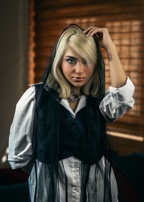 Free Portrait of a woman in black headscarf and formal wear indoors. Stock Photo