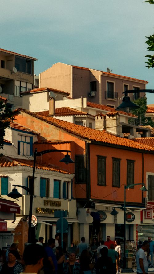 Free Sunlit Mediterranean street lined with vibrant colored buildings, capturing cultural essence. Stock Photo