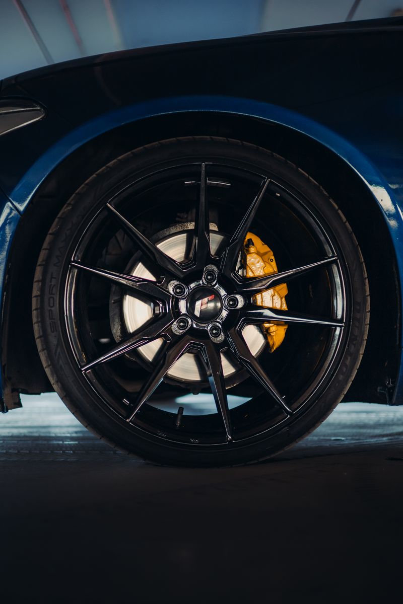 Close-up of wheel and brake assembly on a performance vehicle after suspension setup