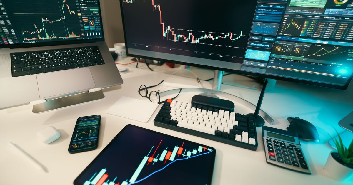 Modern trading desk with multiple screens showing financial charts, illustrating types of trading styles in forex