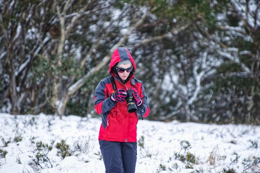 Person enjoying a winter hike in snowy landscape, dressed warmly for outdoor adventure.