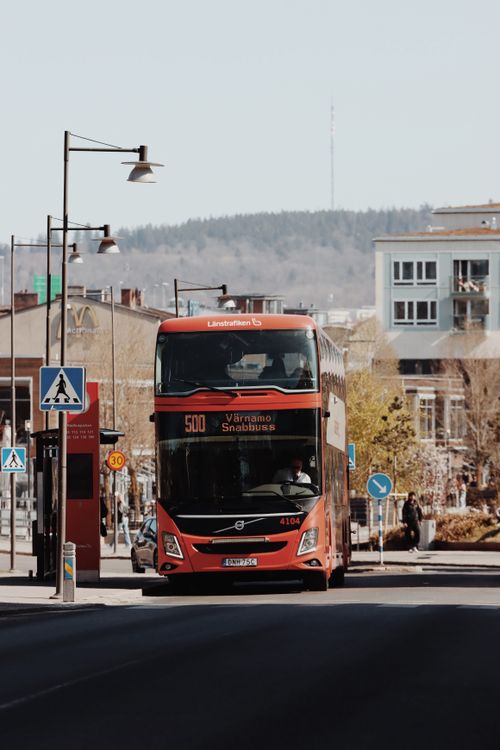 Free A red double-decker bus on a street in Jönköping, Sweden, showcasing Nordic architecture and urban life. Stock Photo